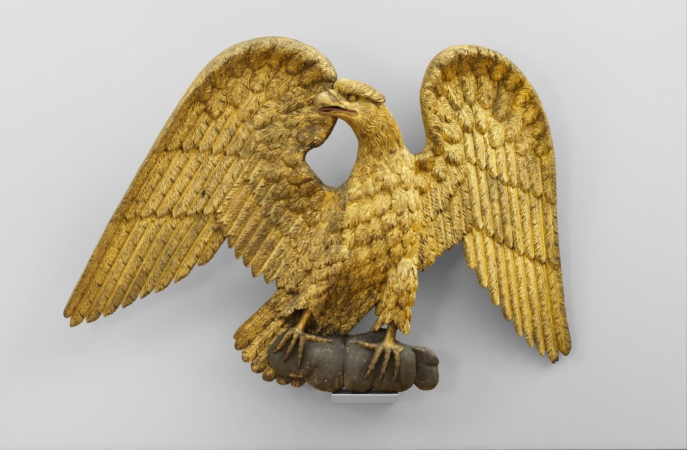 A gilded pine eagle, 1800–1830, from the American Wing of the Metropolitan Museum of Art.