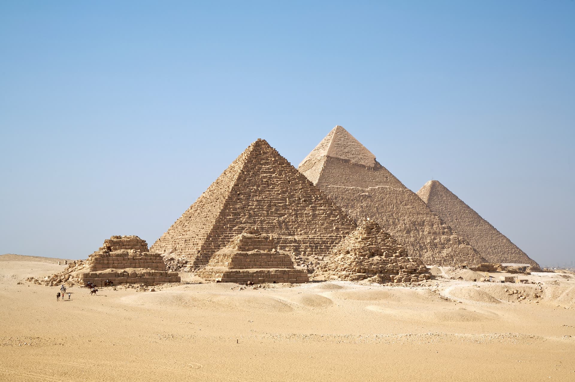 The pyramids at Giza in a modern photograph under a clear sky.